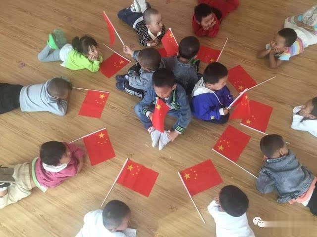 伊吾縣淖毛湖鎮中心幼兒園開展“我和國旗共合影”活動